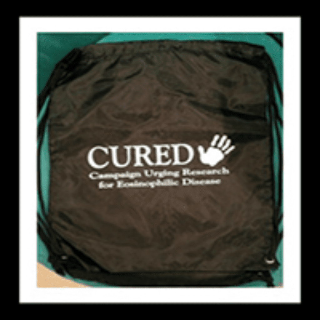 Black drawstring bag with "CURED" logo.