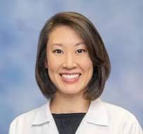 Smiling professional woman wearing white coat